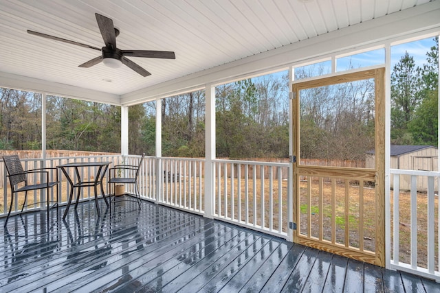 sunroom featuring ceiling fan and a healthy amount of sunlight