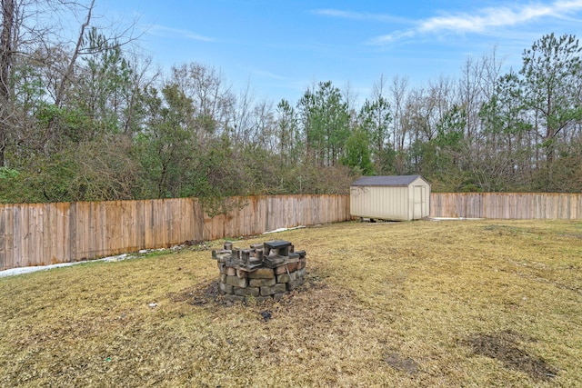 view of yard with an outdoor fire pit and a storage unit