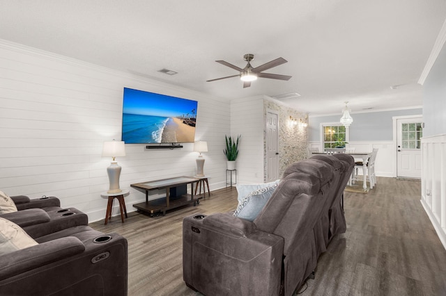 living room with hardwood / wood-style flooring, crown molding, and ceiling fan