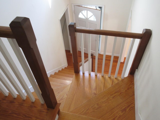 stairway with hardwood / wood-style flooring