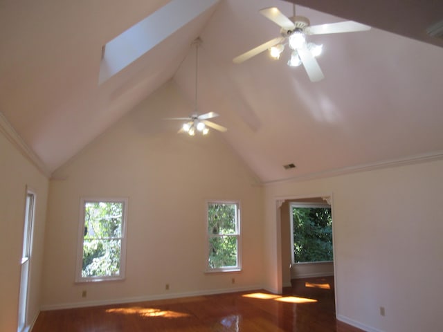 spare room with dark hardwood / wood-style flooring, a wealth of natural light, and ceiling fan