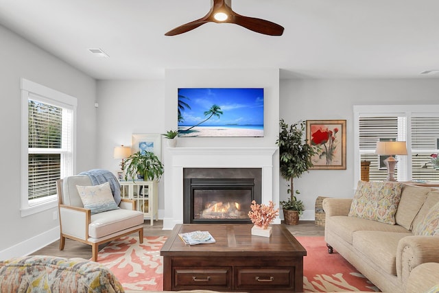 living room with hardwood / wood-style flooring and ceiling fan