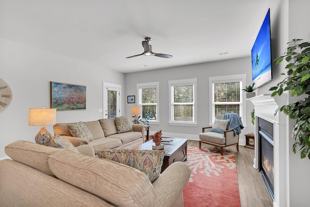 living room featuring ceiling fan and light wood-type flooring