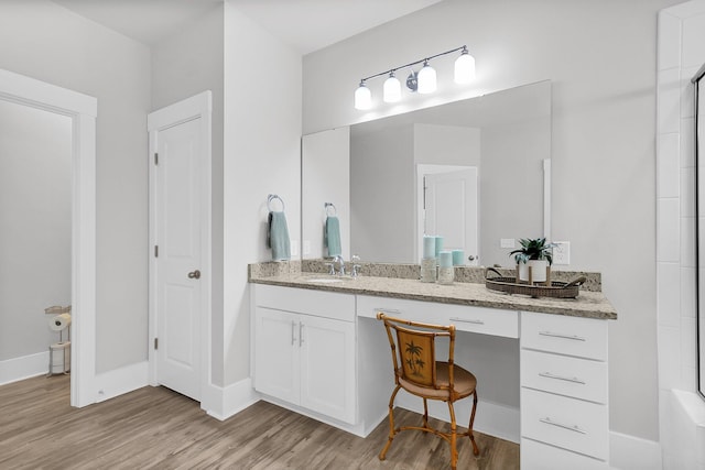 bathroom with vanity and hardwood / wood-style flooring