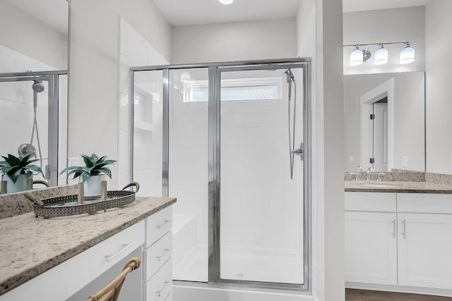 bathroom with vanity and a shower with shower door