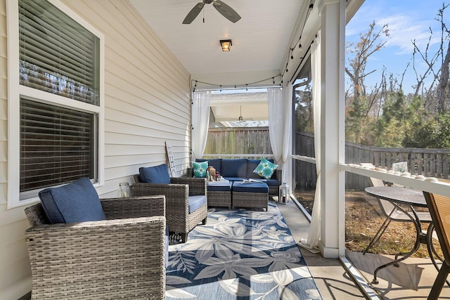 sunroom / solarium featuring ceiling fan