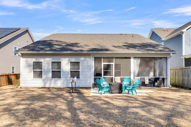 rear view of property with a sunroom and a patio