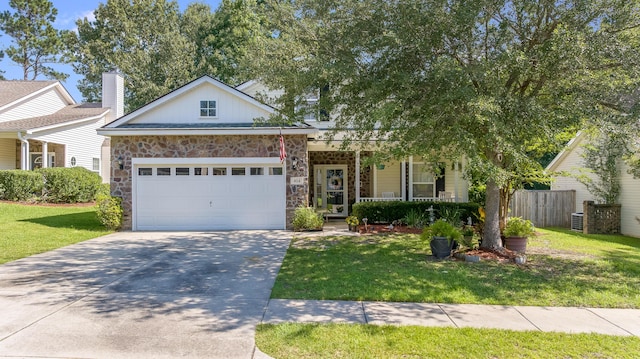404 Norwood Ct, Moncks Corner, SC 29461 - view of front of home featuring stone siding, driveway, a garage, and covered porch