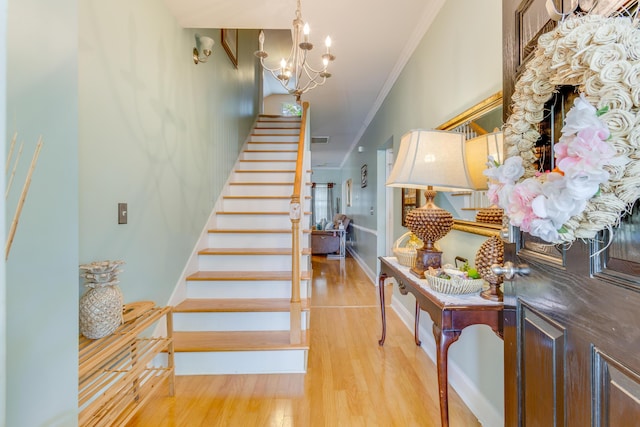 404 Norwood Ct, Moncks Corner, SC 29461 - stairway featuring ornamental molding, wood finished floors, and a chandelier