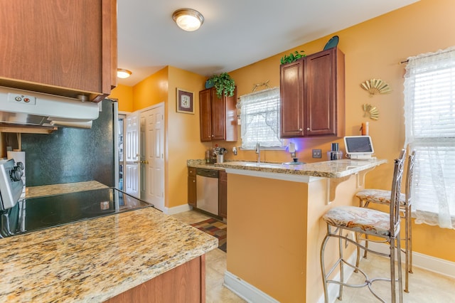 404 Norwood Ct, Moncks Corner, SC 29461 - kitchen featuring a breakfast bar, stainless steel dishwasher, a peninsula, extractor fan, and light stone countertops