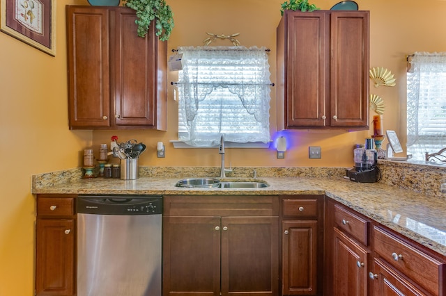 404 Norwood Ct, Moncks Corner, SC 29461 - kitchen with stainless steel dishwasher, light stone countertops, and brown cabinets