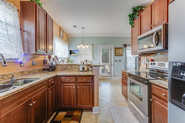 404 Norwood Ct, Moncks Corner, SC 29461 - kitchen with appliances with stainless steel finishes, a chandelier, a peninsula, ornamental molding, and hanging light fixtures
