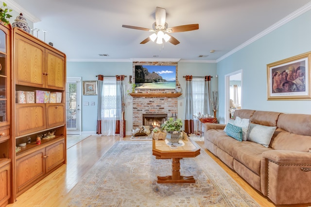 404 Norwood Ct, Moncks Corner, SC 29461 - living area with ceiling fan, light wood-style floors, a fireplace, and ornamental molding