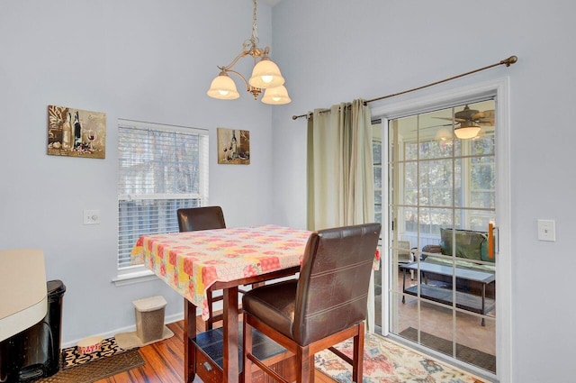 dining area featuring an inviting chandelier, baseboards, and wood finished floors