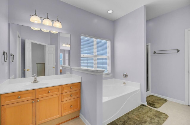 full bath with baseboards, vanity, and a garden tub