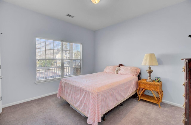 carpeted bedroom with visible vents and baseboards