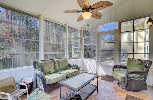 sunroom with ceiling fan and vaulted ceiling