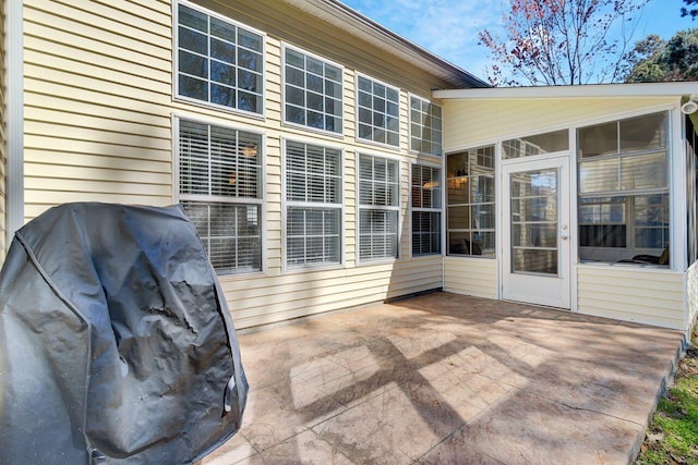 view of patio / terrace with grilling area and a sunroom