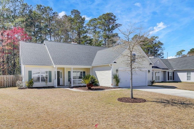 view of front of house featuring a front yard, fence, driveway, an attached garage, and covered porch