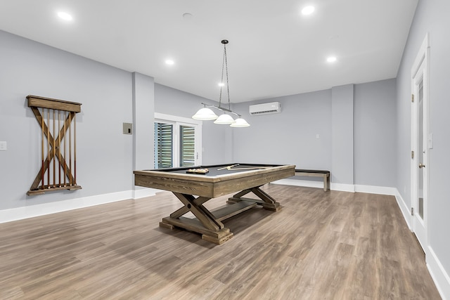 game room with a wall mounted air conditioner, baseboards, light wood-style flooring, and pool table