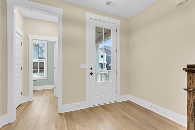 entryway with visible vents, baseboards, and light wood finished floors