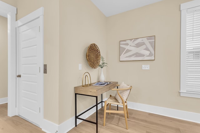 office area with light wood finished floors and baseboards