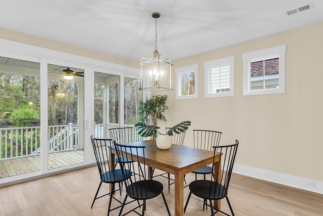 dining area featuring visible vents, light wood-style floors, and a healthy amount of sunlight