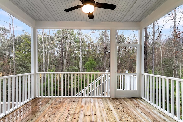 unfurnished sunroom featuring a ceiling fan