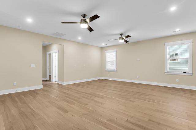 spare room with visible vents, light wood-style flooring, recessed lighting, baseboards, and ceiling fan