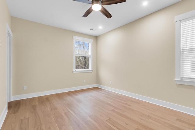 spare room with visible vents, light wood-type flooring, and baseboards