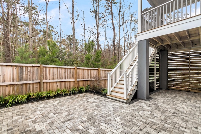 view of patio / terrace with stairway and fence