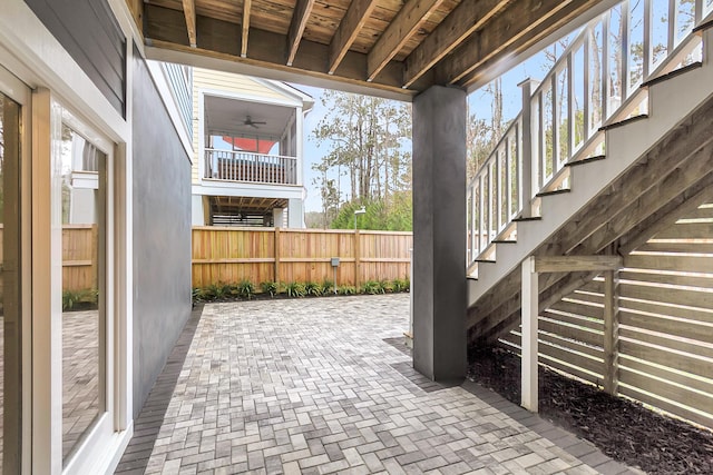 view of patio / terrace with stairway and fence