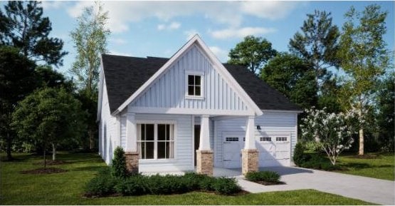 view of front of property featuring a front yard and a garage