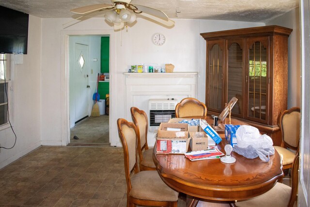 dining space with heating unit, baseboards, and ceiling fan