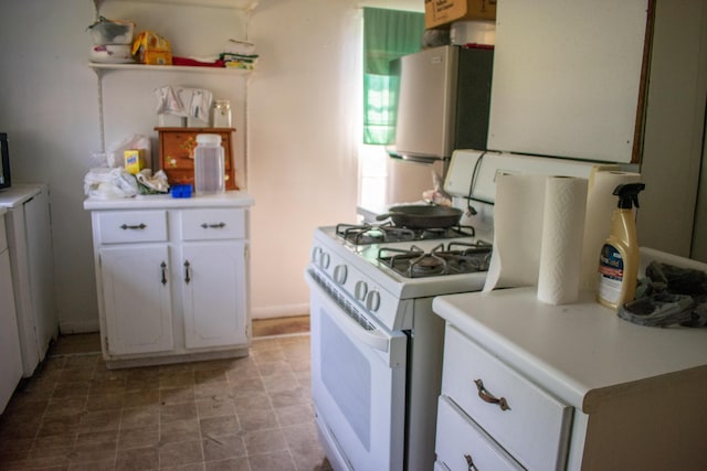 kitchen featuring white cabinetry, open shelves, light countertops, and gas range gas stove