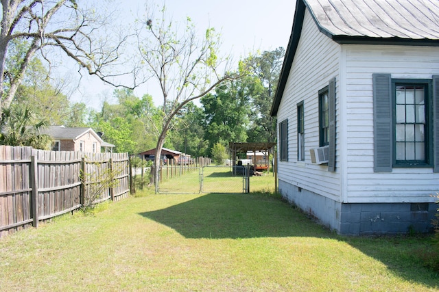view of yard with a gate, fence, and cooling unit