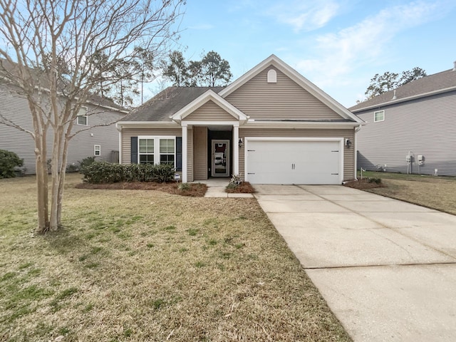 view of front facade featuring a front yard, concrete driveway, and an attached garage