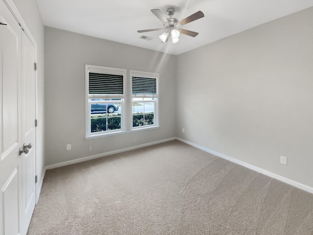 unfurnished bedroom with visible vents, baseboards, carpet, and a closet