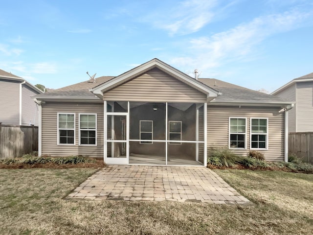 back of house featuring a patio, fence, a yard, a sunroom, and a shingled roof