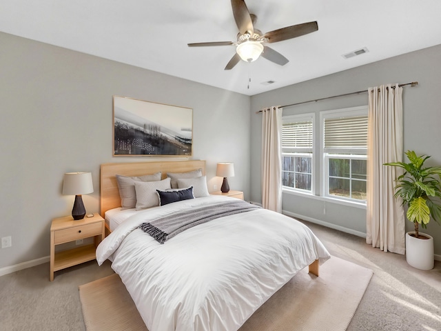 bedroom featuring visible vents, baseboards, carpet, and a ceiling fan