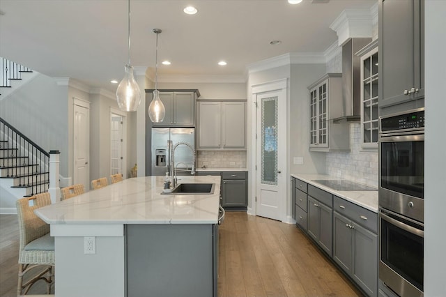 kitchen with appliances with stainless steel finishes, a kitchen bar, and gray cabinets