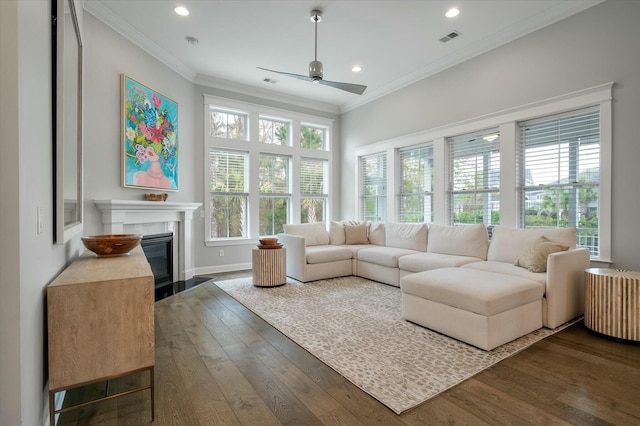 living room featuring dark wood-type flooring, ceiling fan, and crown molding