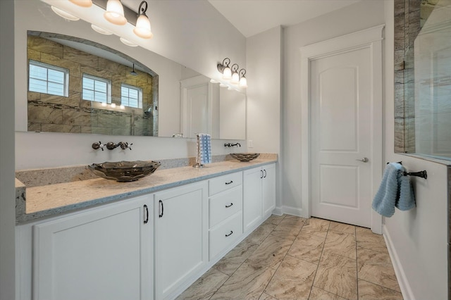 bathroom featuring a shower and vanity