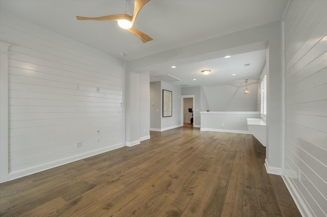 unfurnished living room featuring ceiling fan and dark hardwood / wood-style flooring