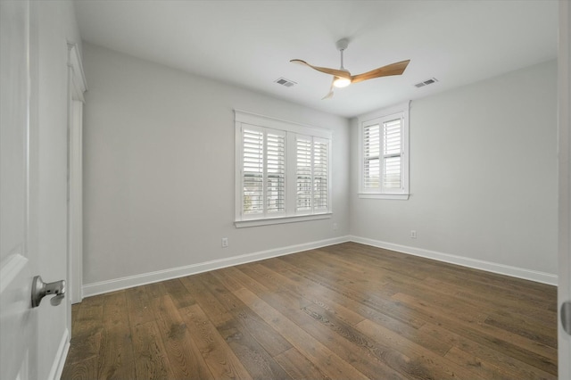 spare room with dark hardwood / wood-style floors and ceiling fan