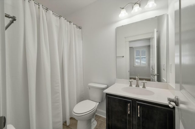 bathroom featuring tile patterned flooring, vanity, and toilet