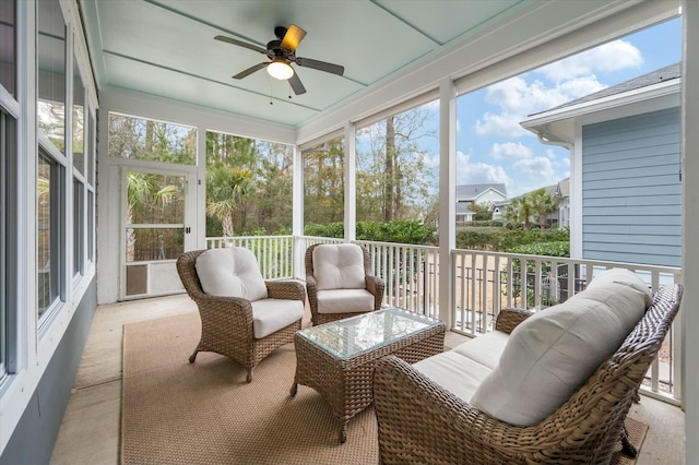 sunroom / solarium featuring ceiling fan