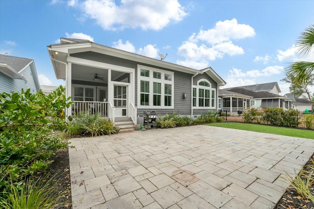 back of property with a patio, a sunroom, and ceiling fan