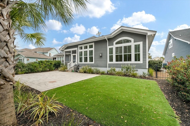 back of house featuring a yard and a patio area