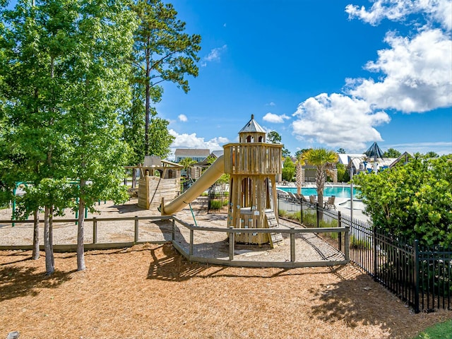 view of jungle gym featuring a community pool